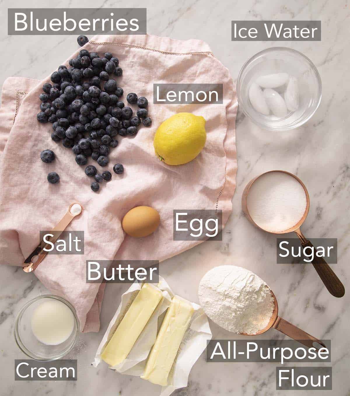 Ingredients for making a blueberry galette on a counter.