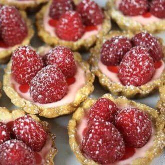 Little raspberry tarts topped with three raspberries each