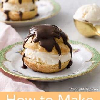 Pinterest graphic of a profiterole on a plate with chocolate drizzle with a second in the background.