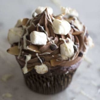 A rocky road cupcake on a white marble table