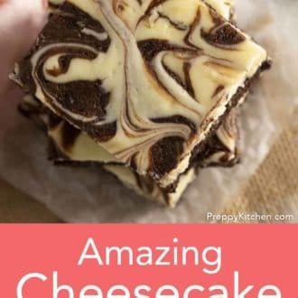 stack of cheesecake brownies on parchment