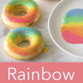 rainbow donuts on a white marble counter