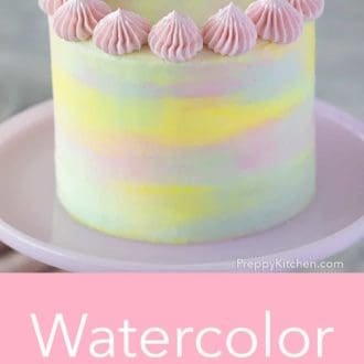 three layer cake with watercolor decoration on a cake stand