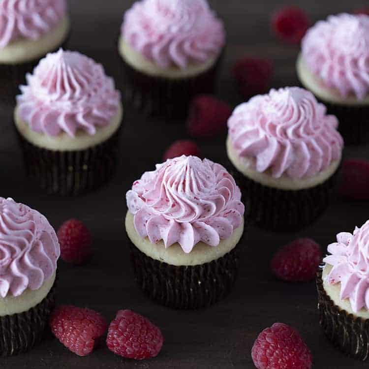 A group of peanut butter and jelly cupcakes on a dark wooden board