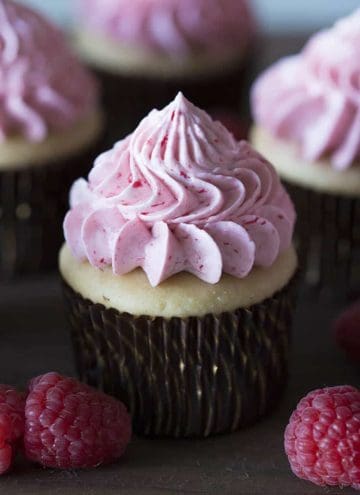 A peanut butter cupcake with a raspberry jelly buttercream dollop.