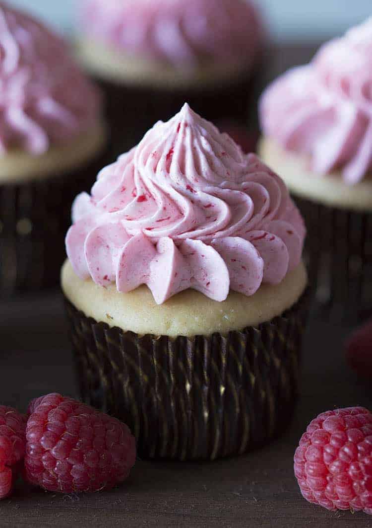A peanut butter cupcake with a raspberry jelly buttercream dollop.