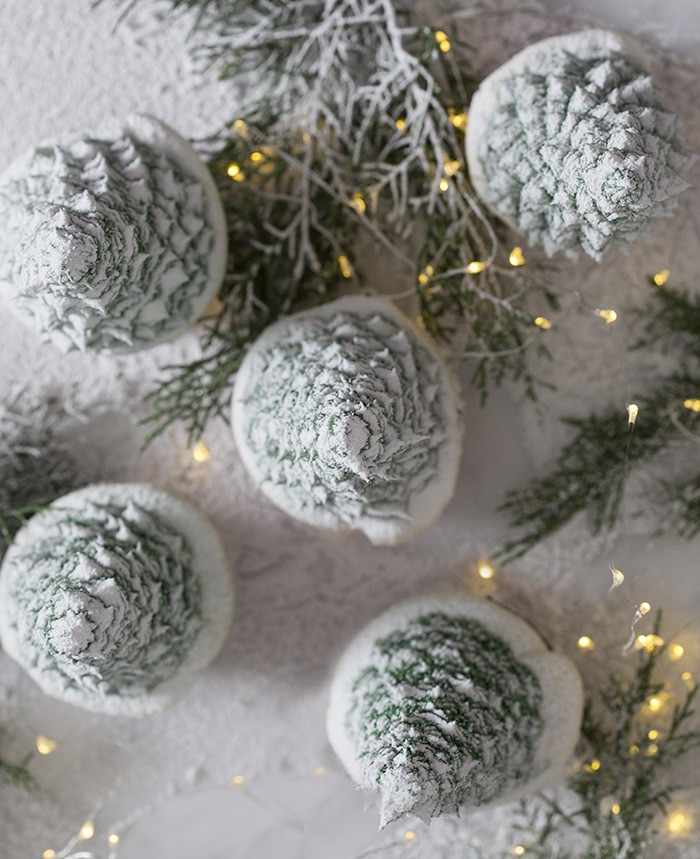 A top down photo of christmas tree cupcakes dusted with powdered sugar