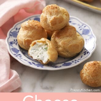 Siix cheese puffs on a marble counter.