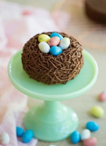 A photo of a Bird’s Nest Easter Cake on a mini cake stand.