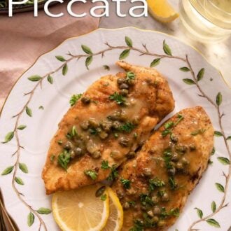 Pinterest graphic of a plate with two chicken piccata with lemon slices.