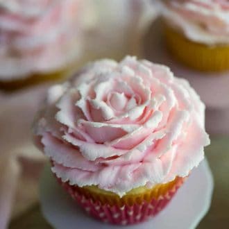A rose cupcake on a mini cake stand.