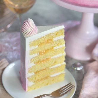 A photo of a champagne cake piece on a white plate