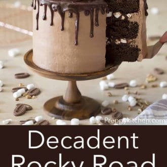 three layer rocky road cake on a wooden cake stand