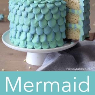 Pinterest graphic of a mermaid cake on a cake stand with a slice being lifted up.
