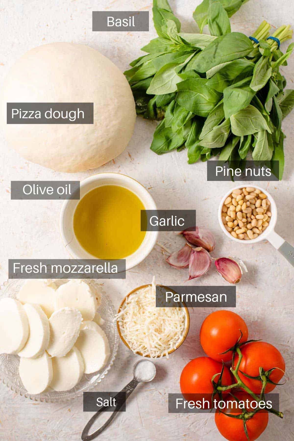 An overhead shot of all the ingredients you need to make a pesto pizza