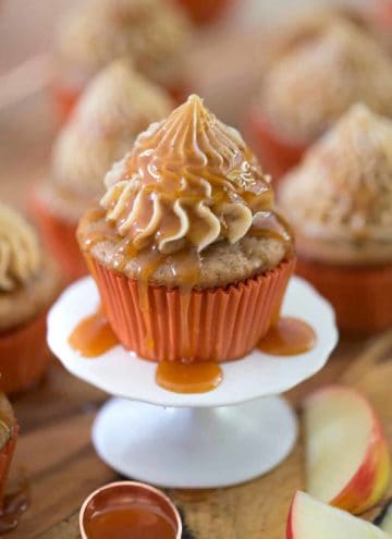 Caramel apple cupcake on a small cake stand.