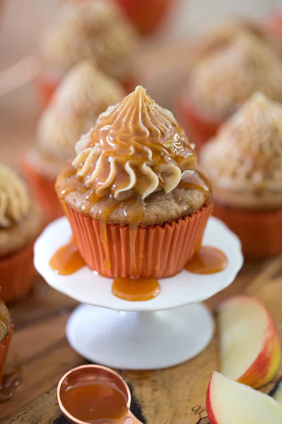 Caramel apple cupcake on a small cake stand.