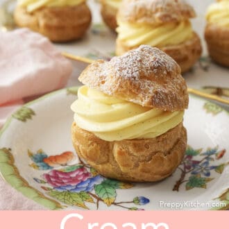 Pinterest graphic of a cream puff with a dusting of powdered sugar on a plate, in front of a platter of them.