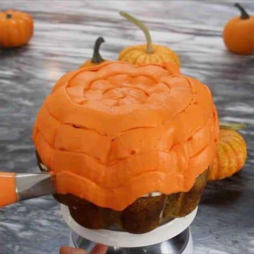 Frosting piped onto a pumpkin bundt cake.