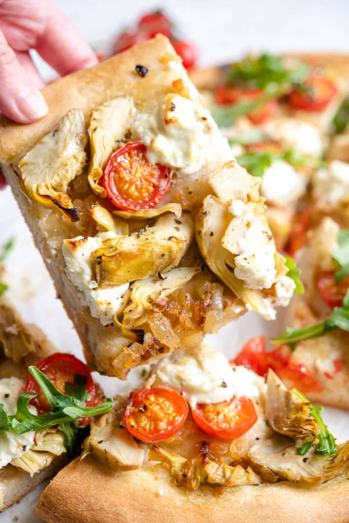 A close up of a slice of Artichoke pizza