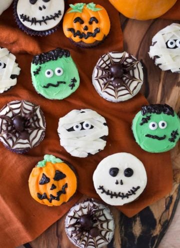 Overhead view of various cupcakes with Halloween decoration.