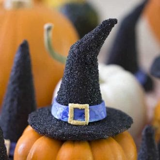 A witch hat cookie pm a mini pumpkin