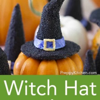 various black witch hat cookies on top of mini pumpkins
