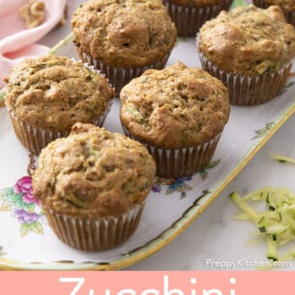 Pinterest graphic of seven zucchini muffins on a tray.