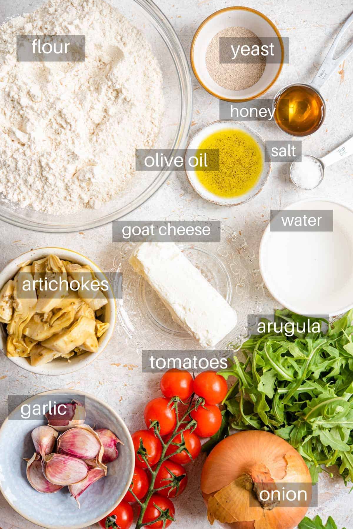 An overhead shot of ingredients you need to make artichoke pizza