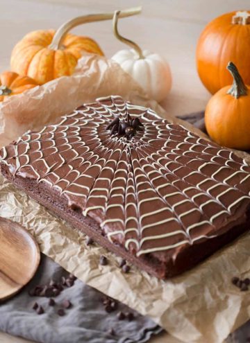 A photo of a chocolate spider web cake with a chocolate spider on top.