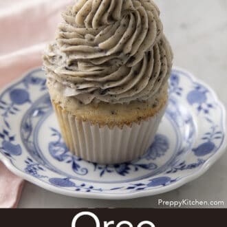 Pinterest graphic of an Oreo cupcake with Oreo frosting on a blue and white plate.
