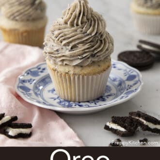 Pinterest graphic of an Oreo cupcake with Oreo frosting on a plate. Broken Oreos on the side.