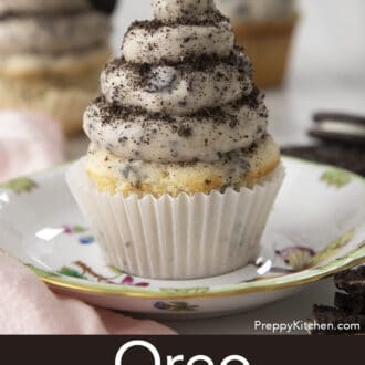 Pinterest graphic of an Oreo cupcake with Oreo frosting on a plate dusted with crumbled cookies.