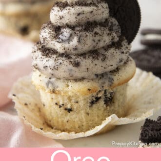 Pinterest graphic of an Oreo cupcake with Oreo frosting on an opened wrapper. Frosting dusted with crushed Oreo cookies and a cookie.