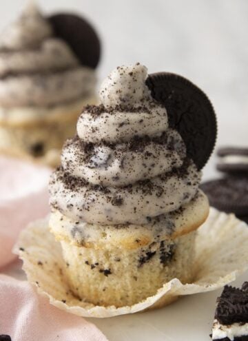 An Oreo cupcake topped with Oreo buttercream and crumbled Oreos.