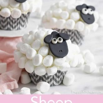 Pinterest graphic of three sheep cupcakes with one on a mini cake stand. Multiple mini marshmallows scattered around.