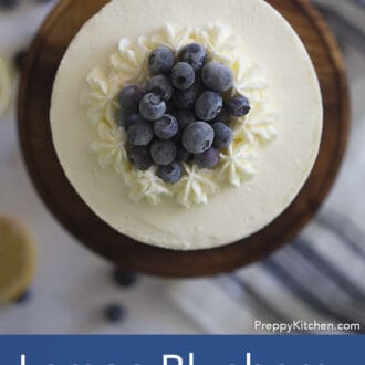 top of three layered lemon blueberry cake with white frosting