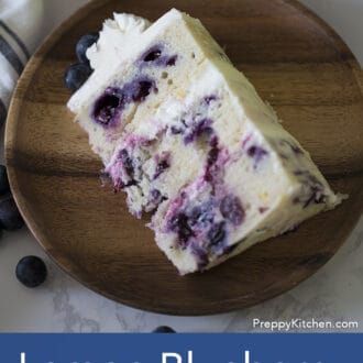 piece of three layered lemon blueberry cake with white frosting