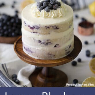 three layered lemon blueberry cake with white frosting