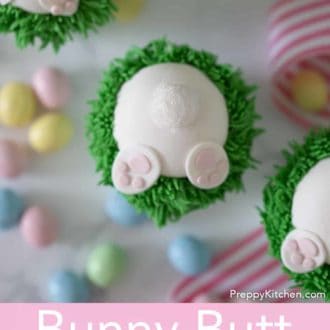 Pinterest graphic of an overhead view of a bunny butt easter cupcake with two more off to the side. Mini chocolate eggs and ribbons scattered around.