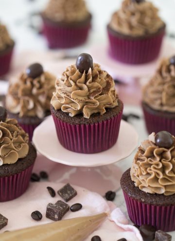 Mocha Cupcakes with chocolate and coffee beans around them.