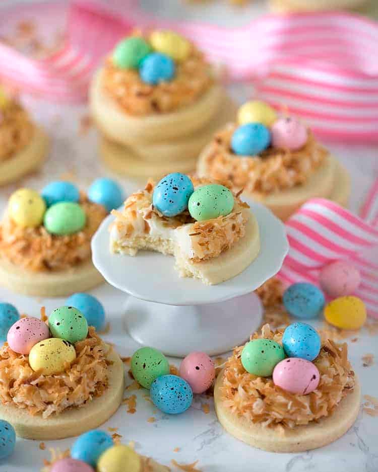 a goup of bird nest easter cookies one with a bite out