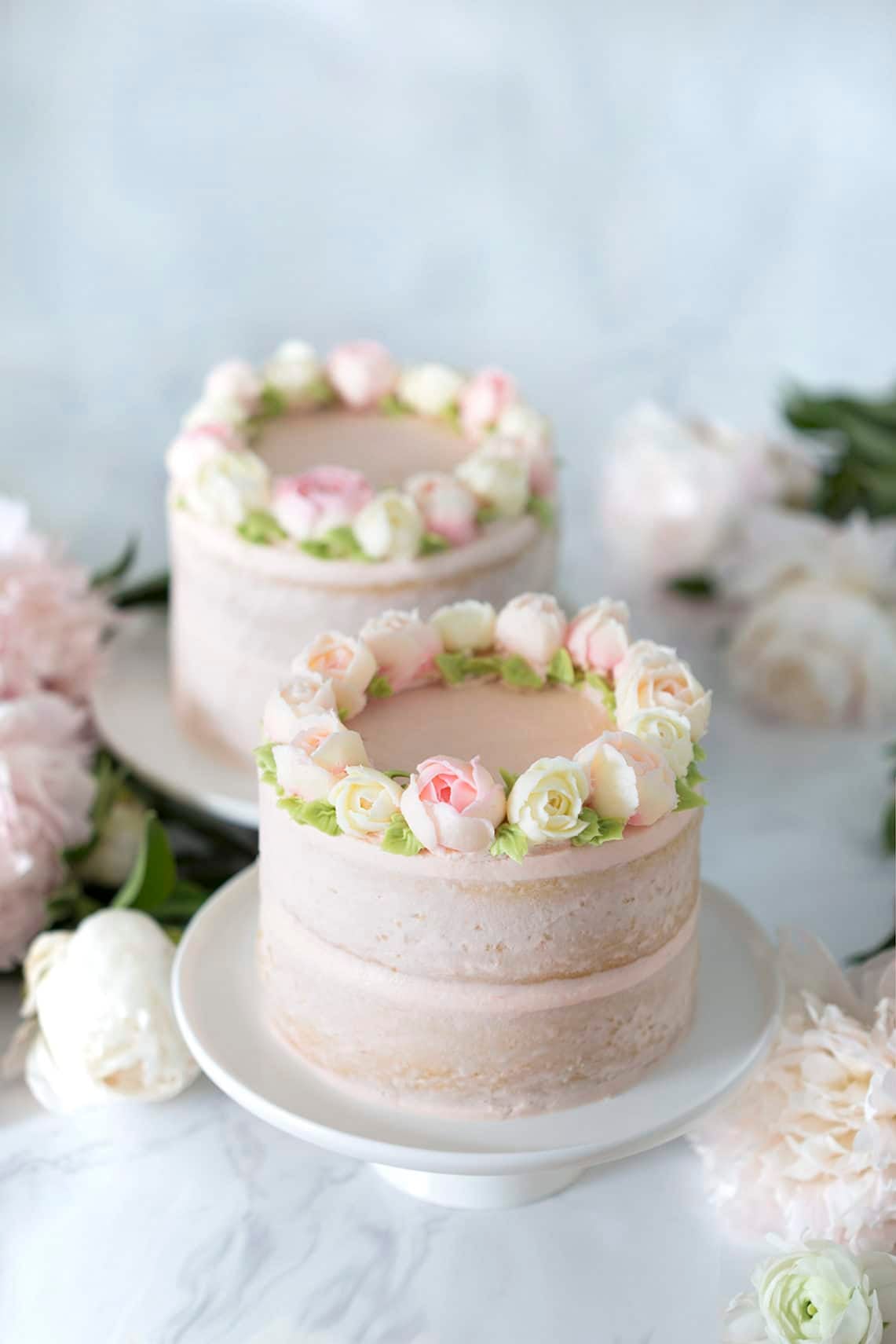 photo of two Smash Cakes on a table with flowers