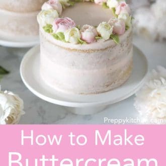 Layer cake topped with buttercream flowers on a cake stand