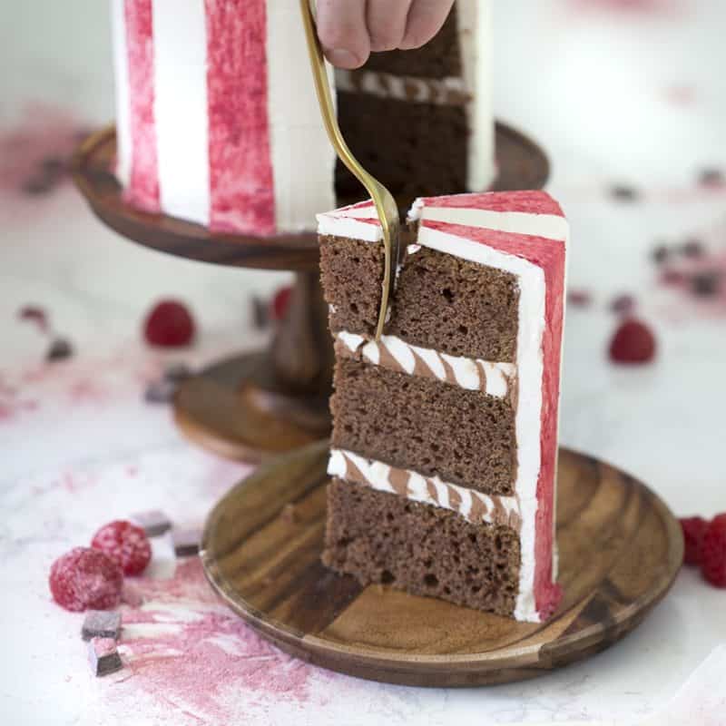 A bite being removed out of a slice of chocolate beet cake.