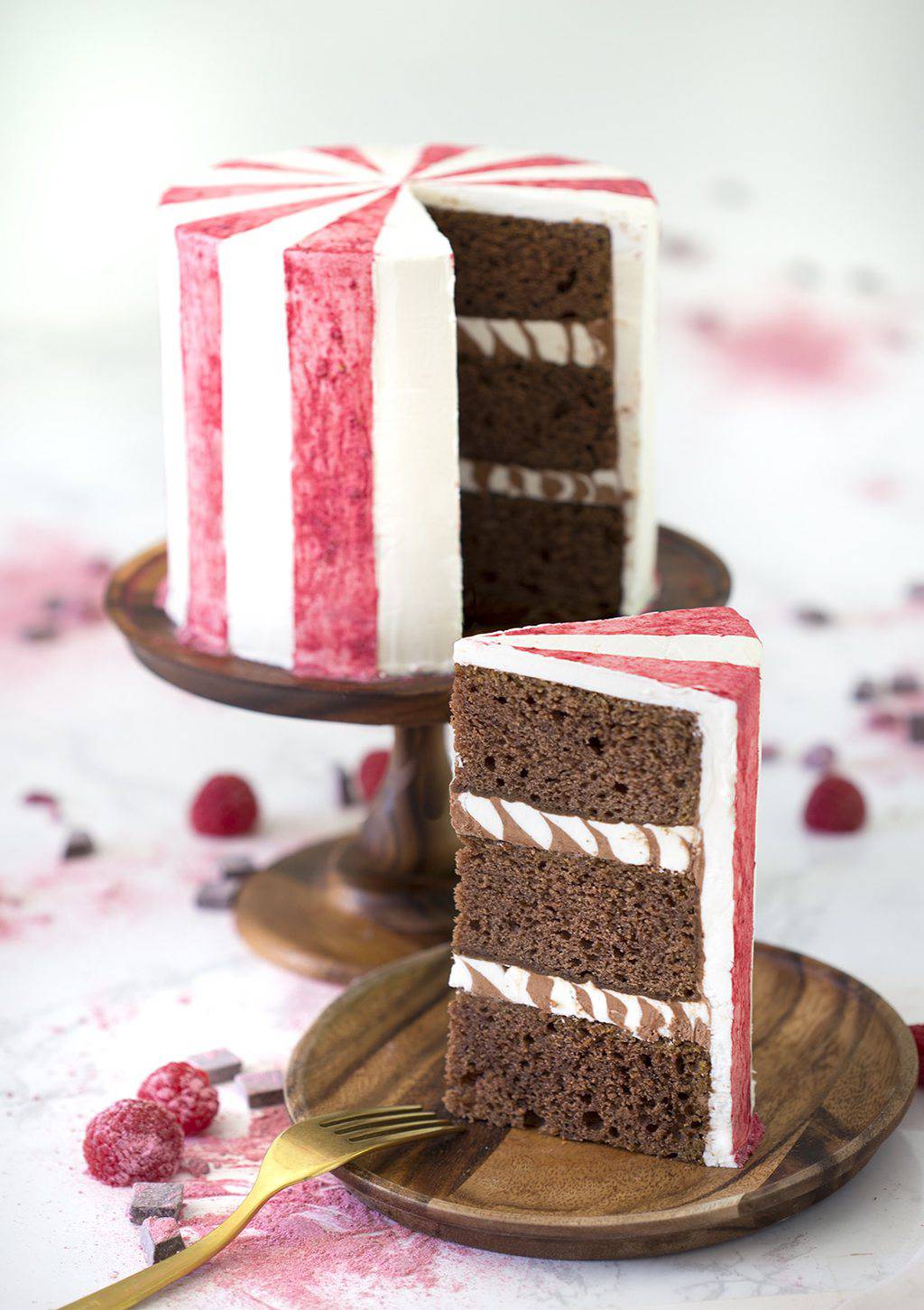 A photo of a chocolate beet cake with a slice on a wooden plate.