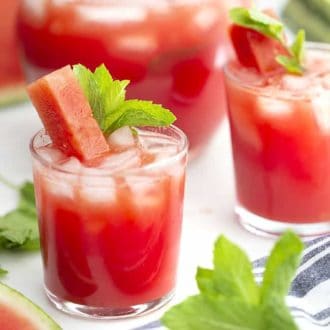 two glasses of watermelon agua fresca with mint leaves for garnish