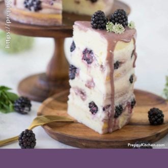 A piece of cake with fresh blackberries, mascarpone buttercream and flowers