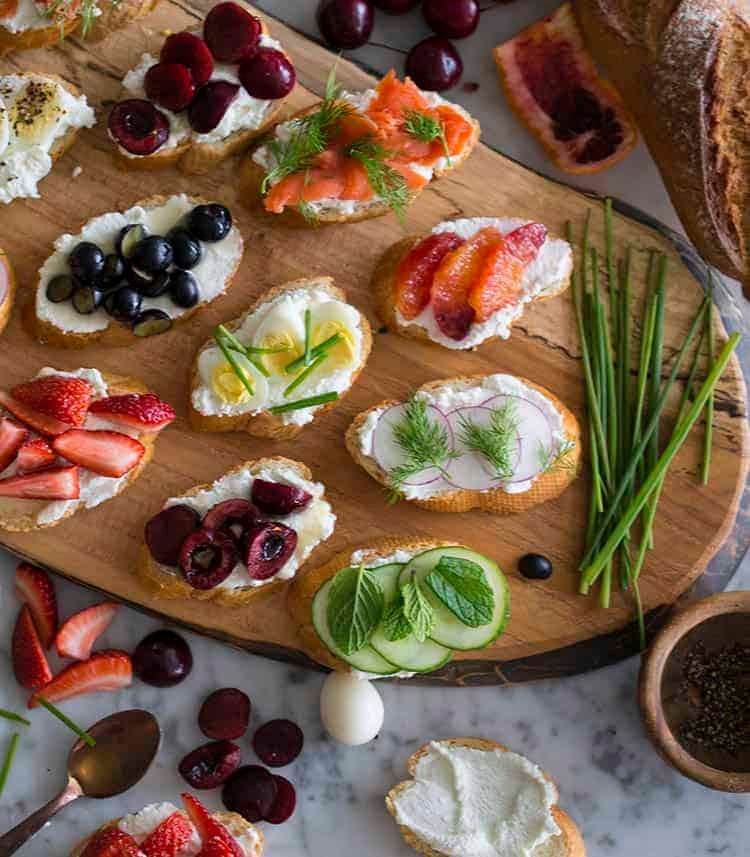 Canapés topped with fresh fruits, vegetables, smoked salmon and quails eggs.