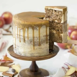 An apple spice cake covered in brown butter frosting and caramel.